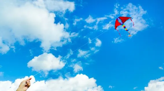 bigstock-Hand-holding-kite-in-the-cloud-102201557