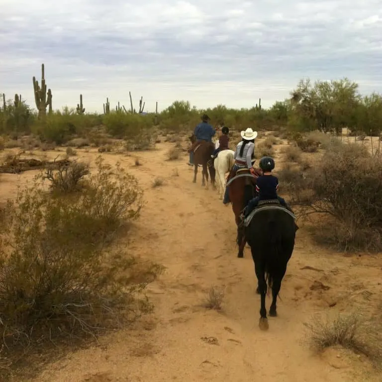 Arizona family vacation include horseback riding in the desert. 