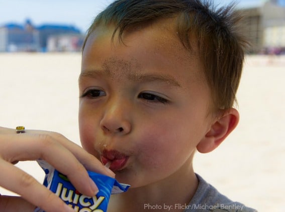 Drinking-juice-beach-kid-trekaroo