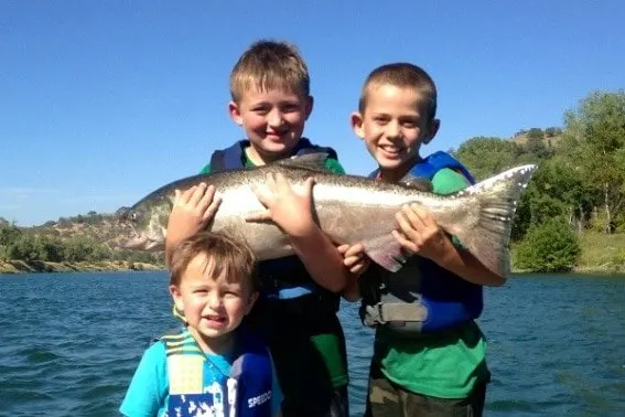 Kids fishing in Redding, California- Just about as good as it gets. Explore Outdoor Activities in Redding, CA - From hiking and biking to fishing, houseboating, exploring national and state parks, caves, and so much more, Redding is much more than a gas stop on your route through Northern California #Redding #trekarooing #familytravel