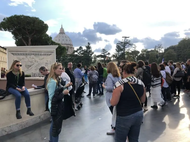 Dark Rome guide navigating through Vatican City crowds