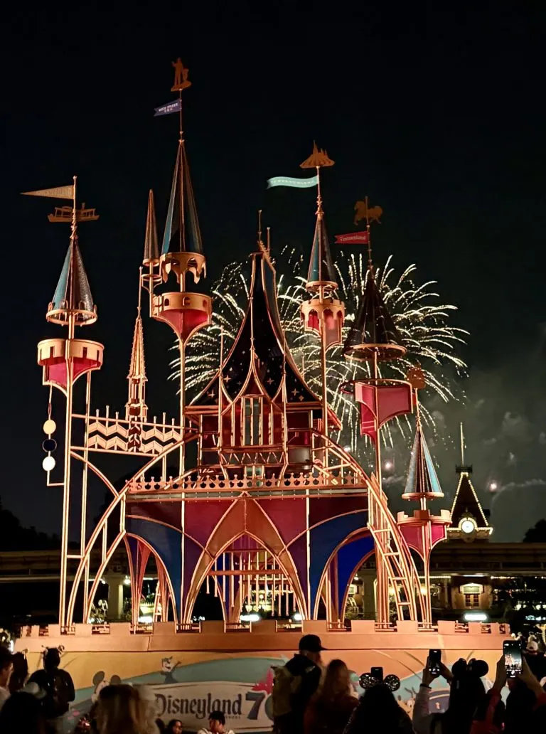 Disneyland 70- What We are Most Excited About 1 Fireworks behind the glass panel sculpture of Sleeping Beauty Castle